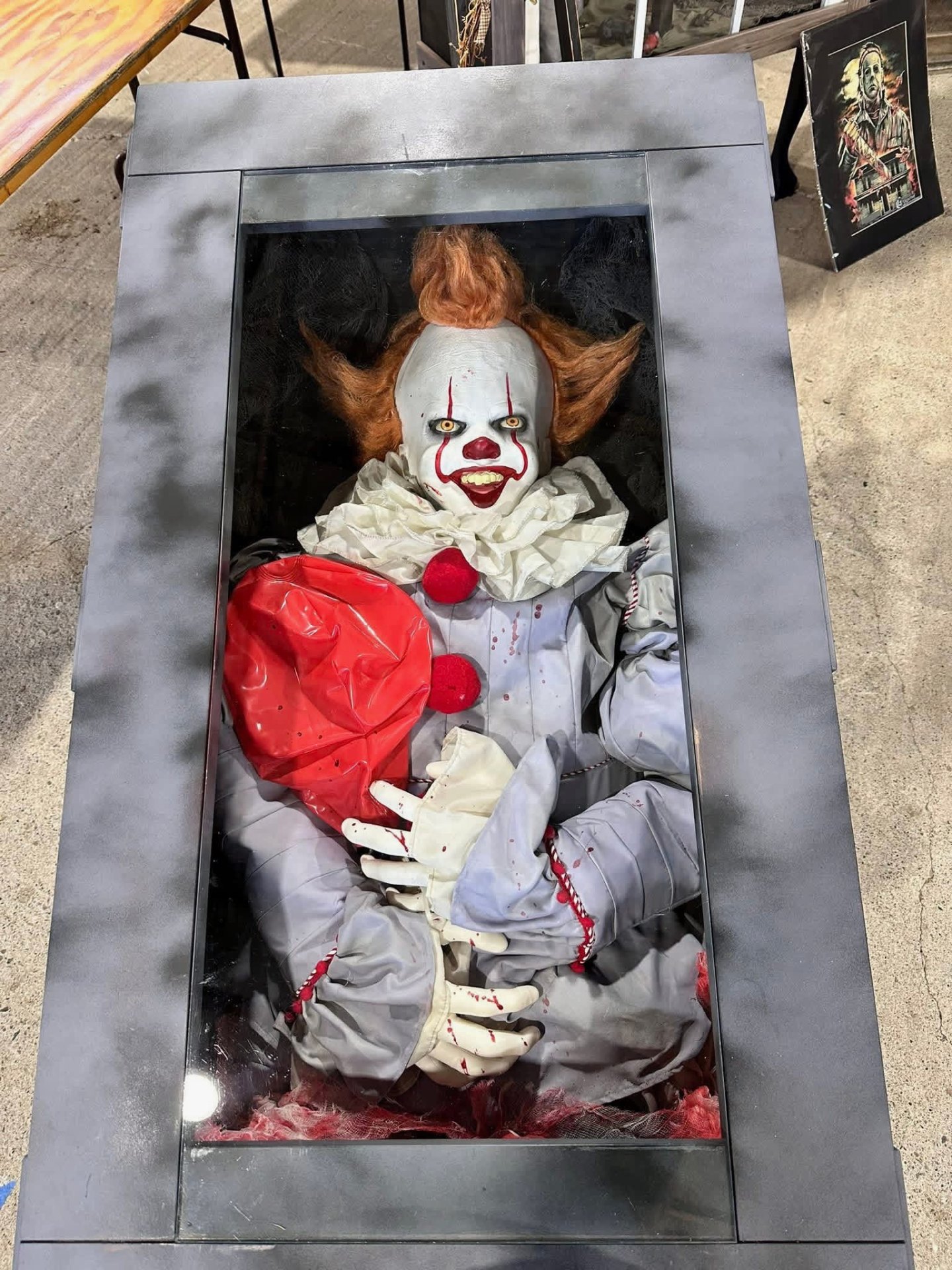 Pennywise the clown with red balloon in steel display case